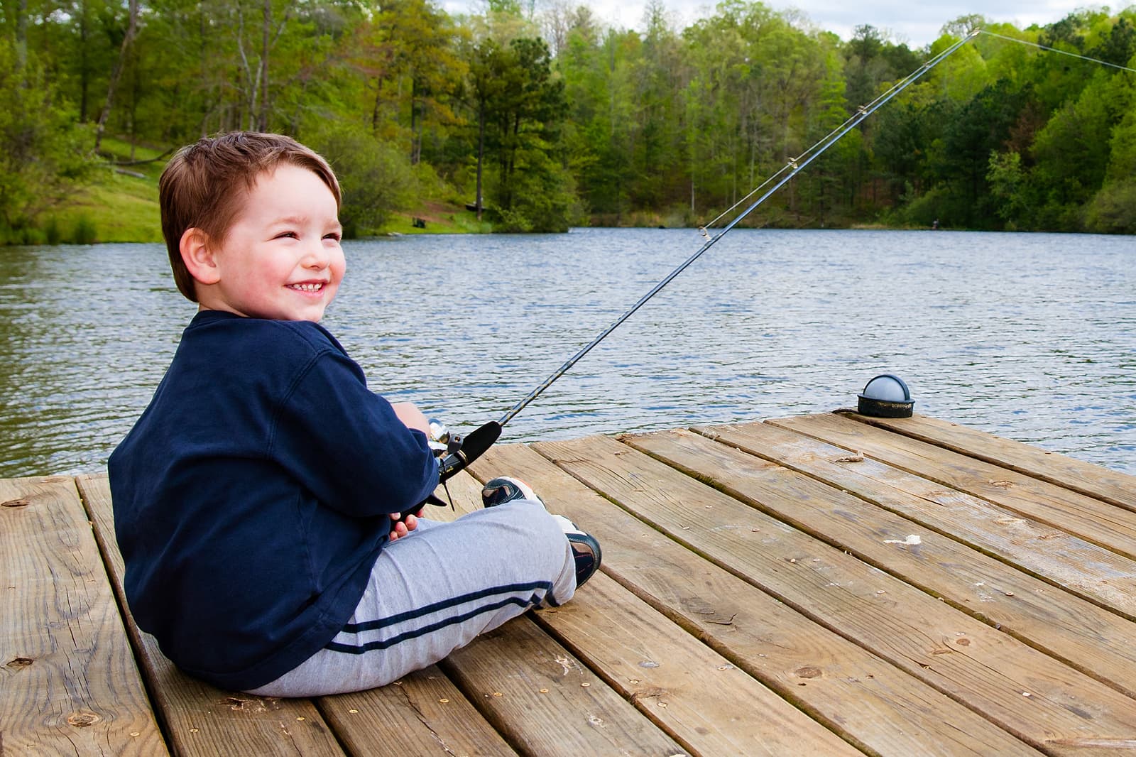 bigstock-Boy-smiles-while-fishing-from--18537422 (1)